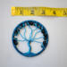 Blue Tree of Life suncatcher with crackle glass beads, wire branches, and a yarn-wrapped hoop displayed with tape measure to show size